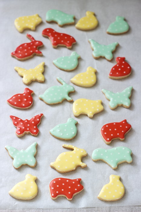Gingerbread or shortbread cookies of various shapes, covered with colored icing. Spring or summer composition.