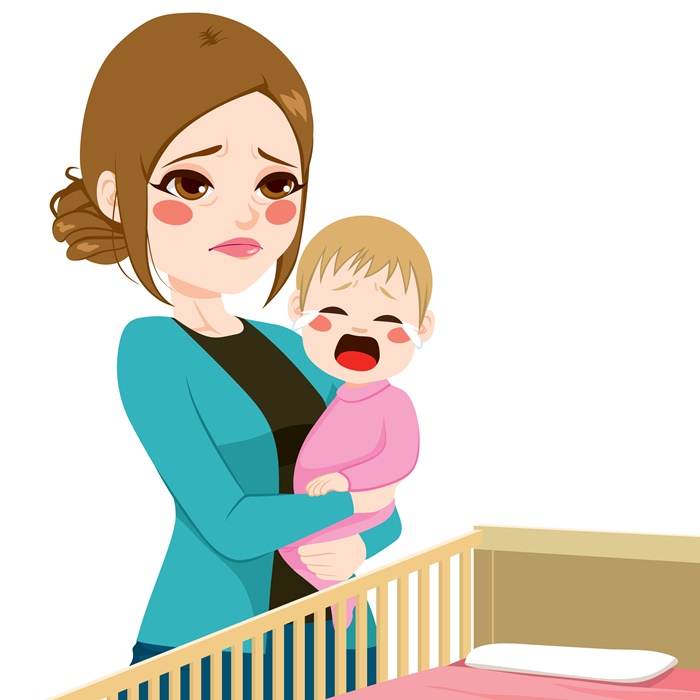 Sleepy Mother Consoling Baby Crying