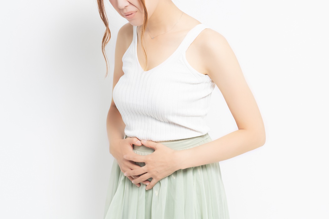 young woman putting her hand on her stomach