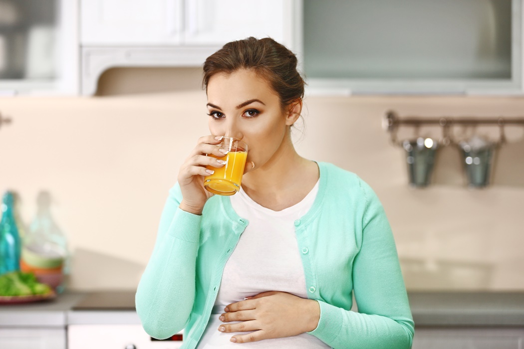 pregnant woman drinking juice