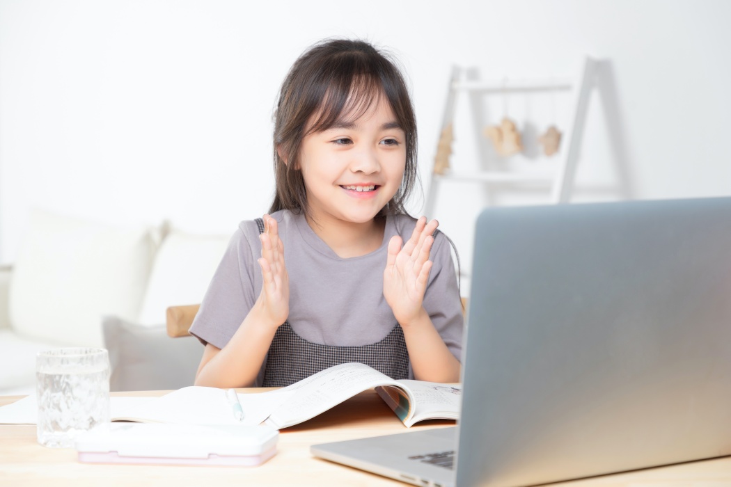 Asian little girl surfing internet at home