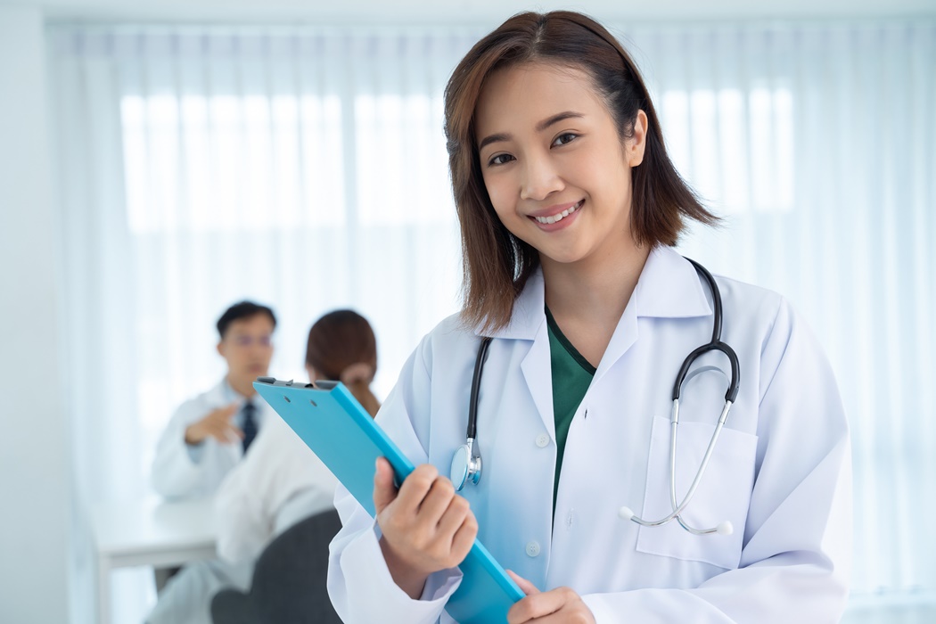 An Asian female doctor smiled friendly while working in the hosp