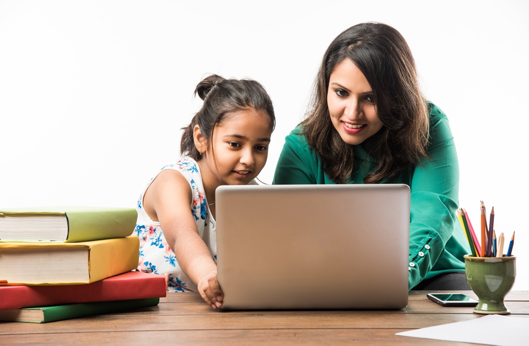 girl studying with mother 