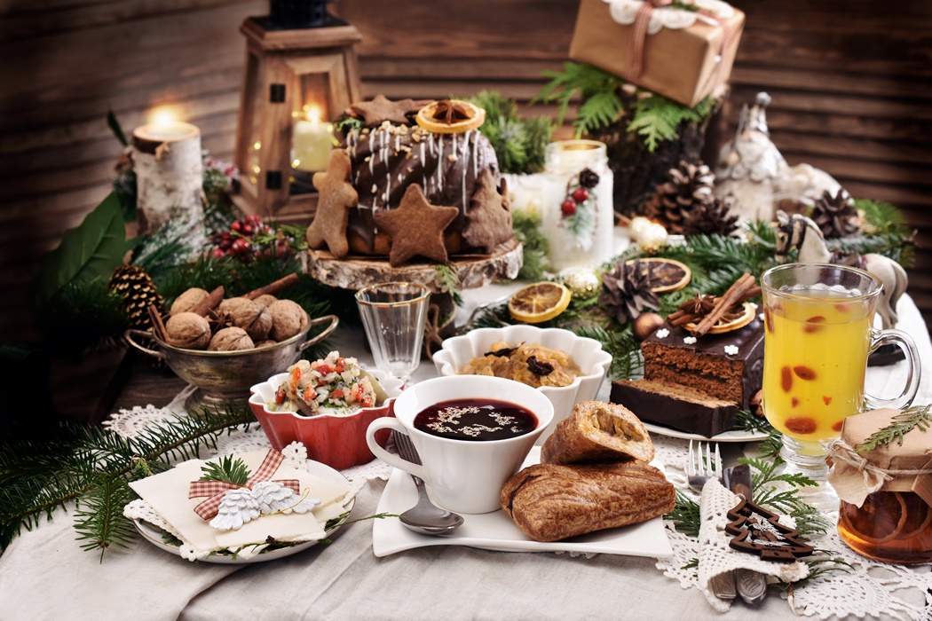 Christmas Eve table with traditional dishes and cakes