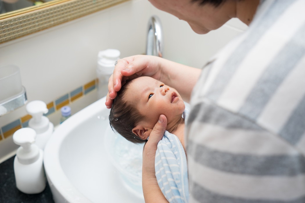 Asian newborn baby having a bath