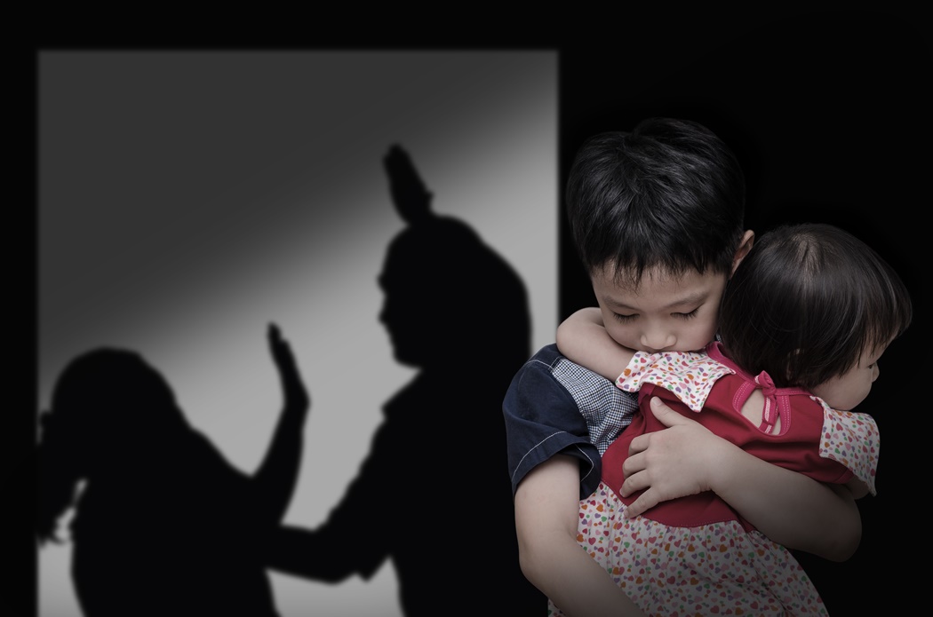 Asian child with his parent fighting in background