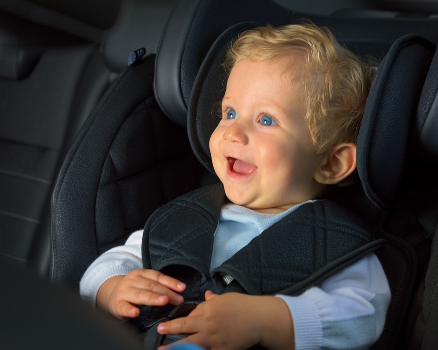 kid boy happy in a car seat