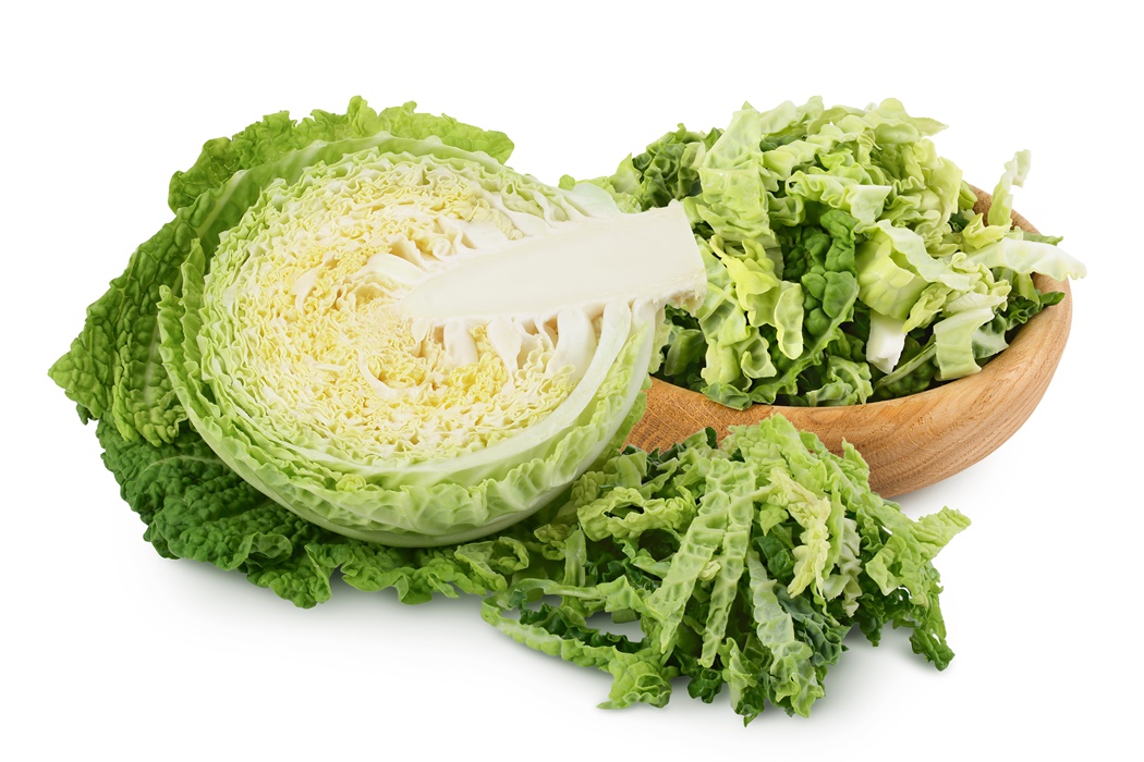 Savoy cabbage half and chopped in wooden bowl isolated on white background with clipping path and full depth of field