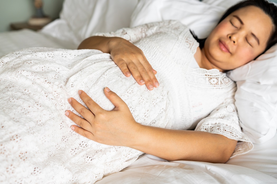 Happy pregnant woman and expecting baby at home.