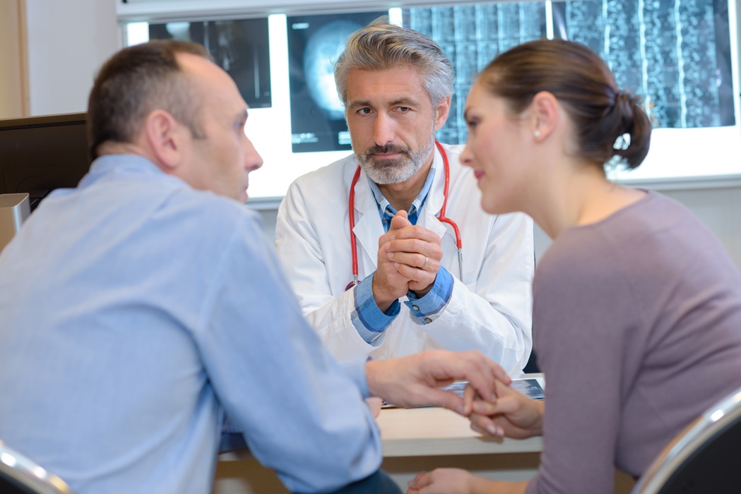 gynecologist talking to couple and options to conceive