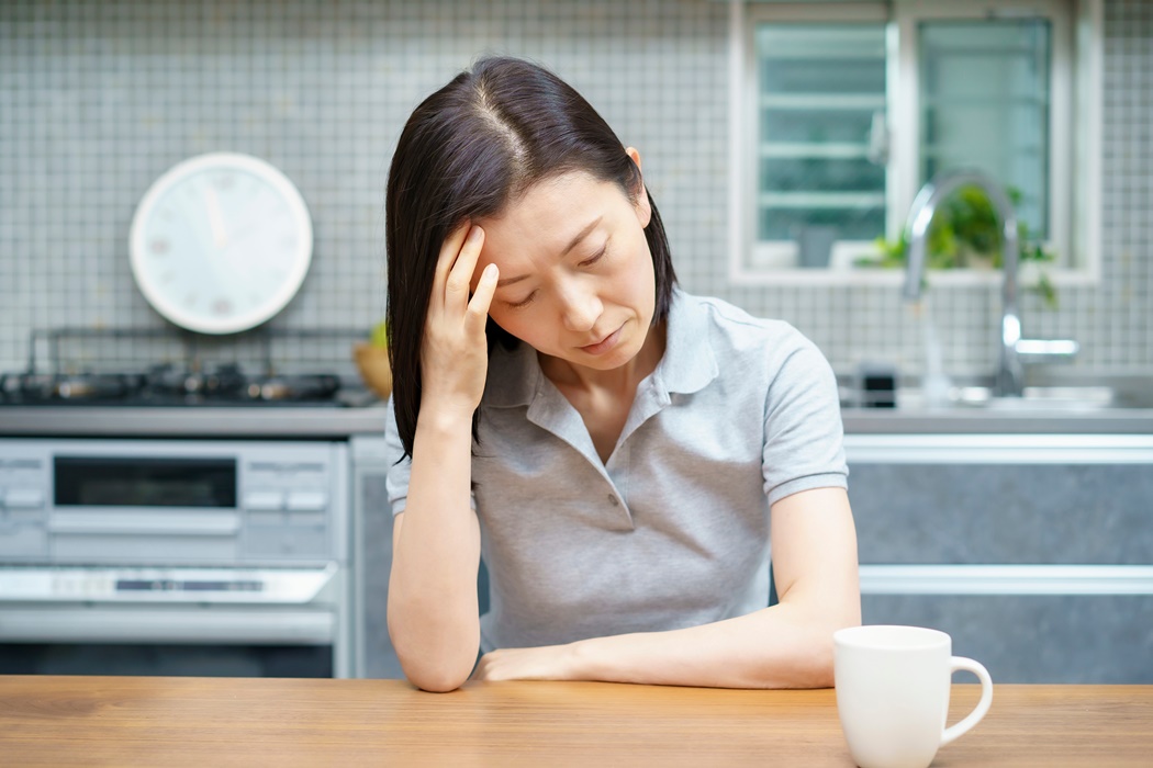 Middle-aged woman suffering from headache