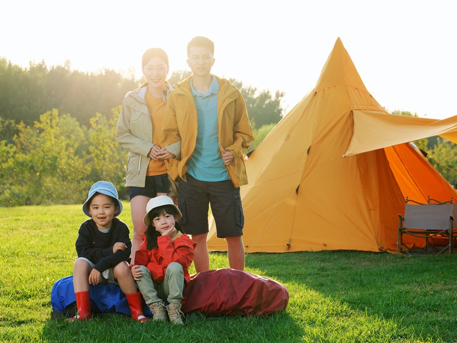 Happy family of four in the outdoor group photo