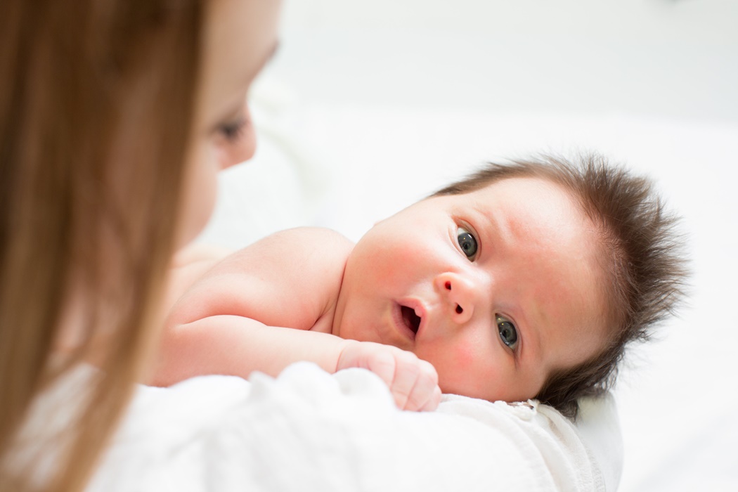 mom holding baby infant