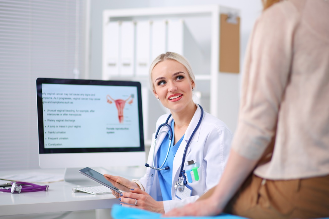 Doctor and patient discussing something while sitting at the table . Medicine and health care concept. Doctor and patient